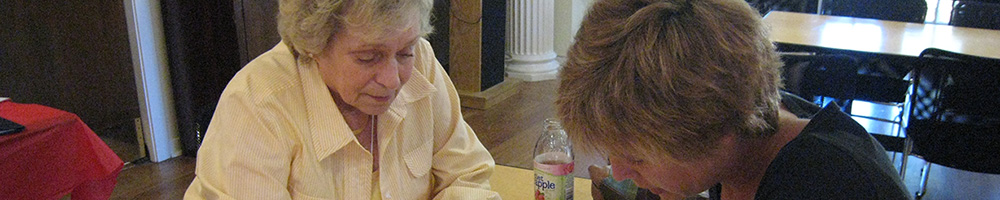 Female volunteer and female international reviewing local information.