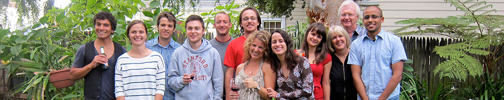 Ten male and female internationals and their Homestay hosts at a backyard party.