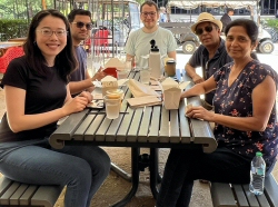 Internationals chatting and enjoying lunch on campus with their host family